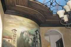 Faux wood and iron with night sky on ceiling, Mural of old town on wall