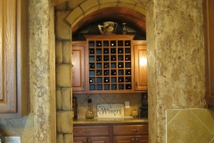 Faux stone wall, wine room. Textured faux finish in kitchen.